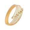 Brazalete Véla Dorado Brazalete rígido dorado de 5 hileras tipo cable trenzado en acero inoxidable.